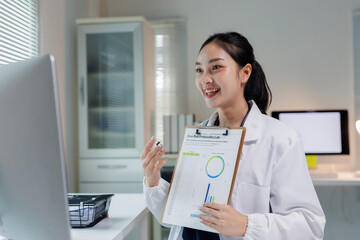 Woman scientist in lab coat having a virtual meeting, presenting scientific data and graphs to colleagues online