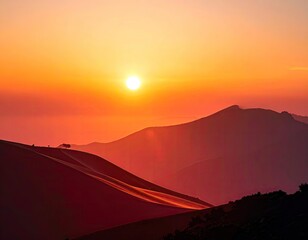 Sunset paints the mountains in fiery hues, casting shadows on the desert landscape