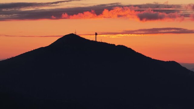 Sunset silhouette of Trebević mountain with communication tower on ridge