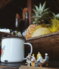 Mini toy of action figure with blurred background. Toy photography concept. Minifigure of worker character with vintage cafe.