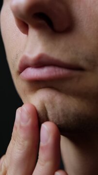 Macro close-up of young man sparse facial stubble, concept of imperfection, insecurity, masculinity. Vertical Video
