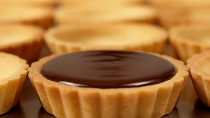 Close-up pouring rich chocolate ganache into golden dessert tart - Powered by Adobe