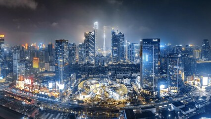 Fototapeta premium Aerial View of Illuminated Modern Cityscape with Skyscrapers at Twilight - Drone Photography of Urban Architecture Complex