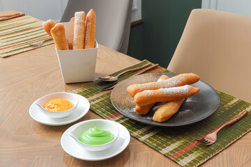 Crispy Dessert Delight: A photorealistic presentation of deep-fried dough sticks, complemented by...