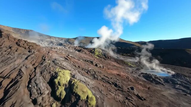 Drone shot slowly descends over a rugged volcanic landscape, showcasing steaming fumaroles and unique geological formations under a clear sky grand, primal, heat