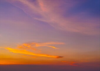 Breathtaking Dusk Sky with Vibrant Purple and Golden Orange Clouds Creating Dramatic Evening Natural Beauty