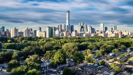 Fototapeta premium Beijing Modern Cityscape with Green Parkland and Residential Neighborhoods Under Cloudy Sky