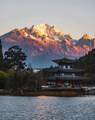 Traditional Chinese Pagoda at Black Dragon Pool with Jade Dragon Snow Mountain at Sunrise, Lijiang, Yunnan, China © Ngo