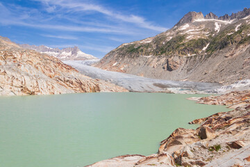 View of the Rhone Glacier and the glacial lake at Furka Pass in the Swiss Alps in canton of Valais, Switzerland