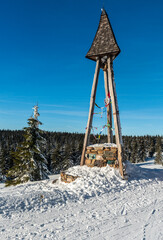 Bell tower near Svycarna hut in winter Jeseniky mountains in Czech republic