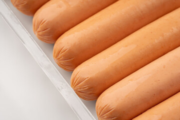 Fresh raw sausages on a white background. Meat products. Sausage. Semi-finished products.