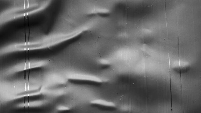 black crumpled and creased plastic bag texture background stop motion
