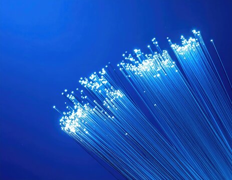 Luminescent bundle of thin strands against a deep blue background - Powered by Adobe