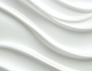 Close-up view of smooth, white cream with curved lines, glossy texture