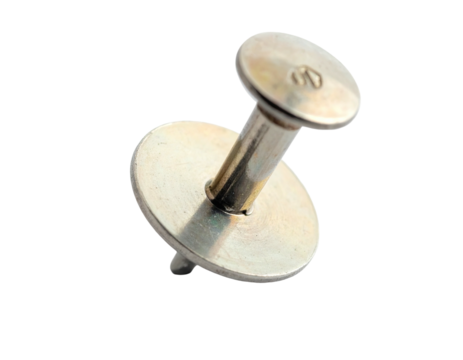 Close-up of a metallic thumbtack with a wide head, angled on a black backdrop