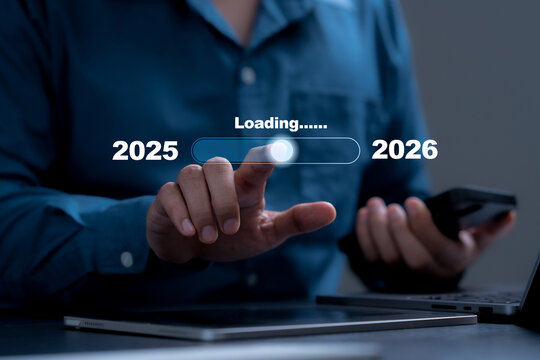 2026 Strategic Planning. Businessman touching virtual loading bar transitioning from 2025 to 2026. Concept for new year's countdown, starting a business plan and future goal setting and resolutions.