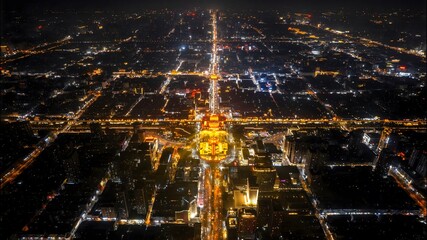 Aerial Night View of Illuminated City with Golden Pagoda Temple Creating Stunning Urban Landscape Photography