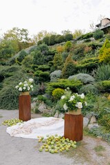 Outdoor Wedding Ceremony Decoration with Floral Arrangement and Apples against Garden Landscaping