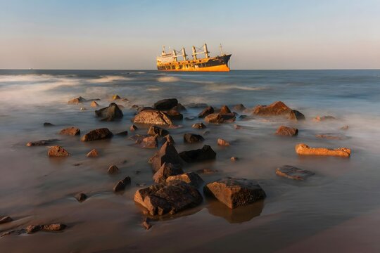 Abandoned Shipwreck on Rocky Coastline at Golden Hour, Weihai China Seaside Destination
