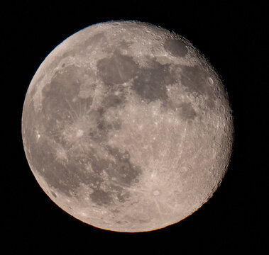 Aerial view of the moon's cratered surface glows with ethereal light against the infinite blackness of space, a celestial pearl, Location Omitted, Location Omitted.