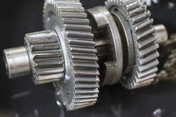 Close up of metal gears, showing intricate machinery and engineering. interlocking teeth suggest...