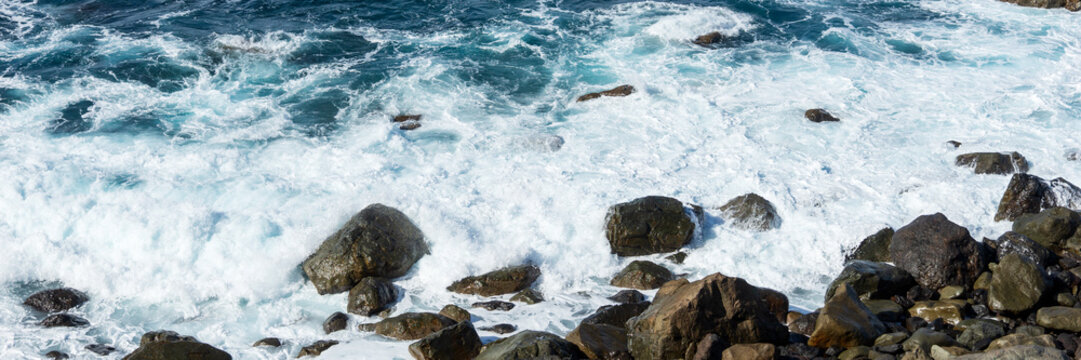 Panoramic image. Waves on the rocky coast