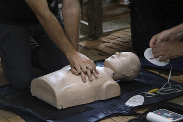 Learn CPR techniques on training dummy with focus on chest compressions and AED pad placement this life saving skill demonstration evokes urgency and preparedness