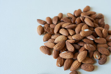 Almond nuts on white background. Selective focus and small depth of field.
