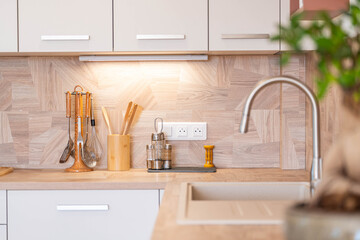 Modern natural wood kitchen interior with warm light
