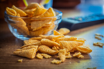 Bugles snack. Cone corn chips on wooden table.