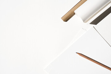 Design Studio. Mockup. Sheets of Paper, Graphite Pencil, Paper Rolls Arrangement on Desk.                          