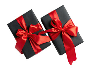 Two black wrapped presents tied with vibrant red satin ribbons