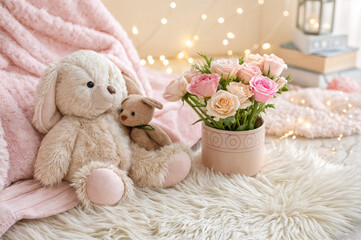 pink background with a soft toy and flowers in a box