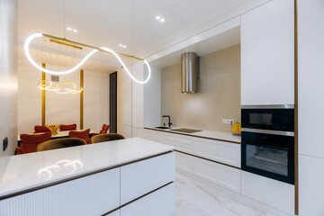A Modern Stylish Kitchen featuring Elegant Lighting along with a spacious Open Layout design