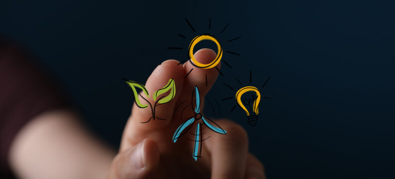 Human hand interacting with a digital interface displaying sustainable green energy concepts like solar, wind, and bioenergy for a cleaner futur - Powered by Adobe