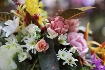 Vibrant floral arrangement evokes joy and celebration, featuring diverse collection of colorful blossoms and lush green foliage