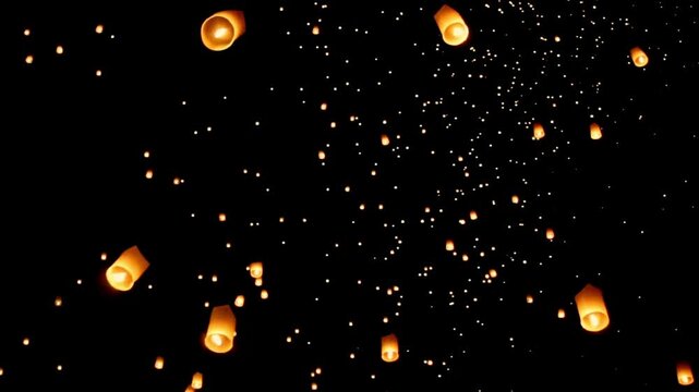 Enchanting Sky Lanterns at Yi Peng Festival, thousands of floating fire paper lanterns in the night sky Chiang Mai Province, Northern Thailand, Asia.
