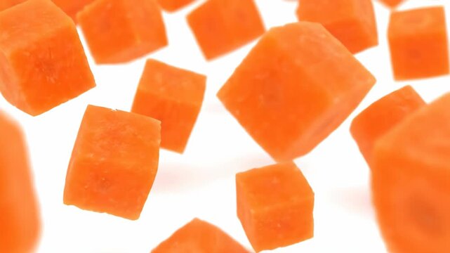 Diced Carrots Floating in Air Against White Background
