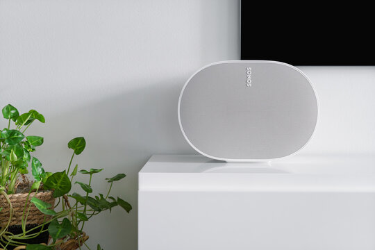 Rusko, Finland - September 25, 2025: White Sonos Era 300 wireless smart speaker placed on a TV stand next to a television in a Scandinavian-style living room interior.