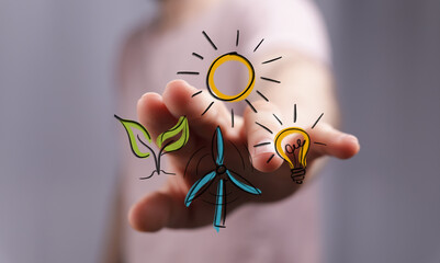 Conceptual image of a hand touching virtual icons representing renewable energy sources like sun,...
