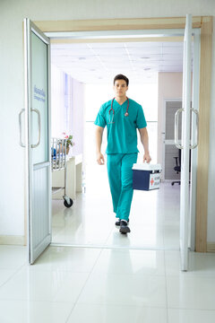 Hospital, healthcare, medical, doctor, nurse holds human organ transport box with serious expression, emphasizing emergency response and responsibility in critical transplant operation, surgeon room