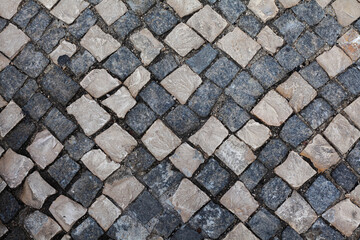 A square shape of multicolored paving stones with a top view.