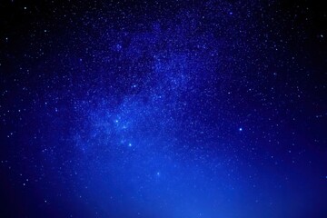 A deep blue night sky filled with countless twinkling stars, creating a serene and mesmerizing cosmic scene