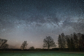 Night sky full of stars. Milky Way above the wheat field.