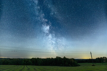 Night sky full of stars. Milky Way above the telegraph poles.