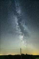 Night sky full of stars. Milky Way above the telegraph poles.