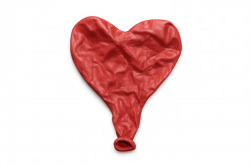 Red deflated heart-shaped rubber balloon lying flat, representing disappointment, broken dreams, and emotional pain on transparent background