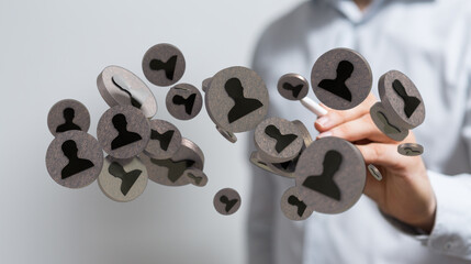 Digital composite of a hand interacting with people icons, representing network connections and teamwork for social media themes.