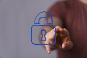A hand interacting with a glowing blue digital padlock icon, symbolizing advanced cybersecurity, data protection, and online privacy solutions.