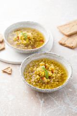 Homemade lentil soup served with basil